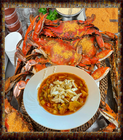 Crab dish with a side of soup on a textured background