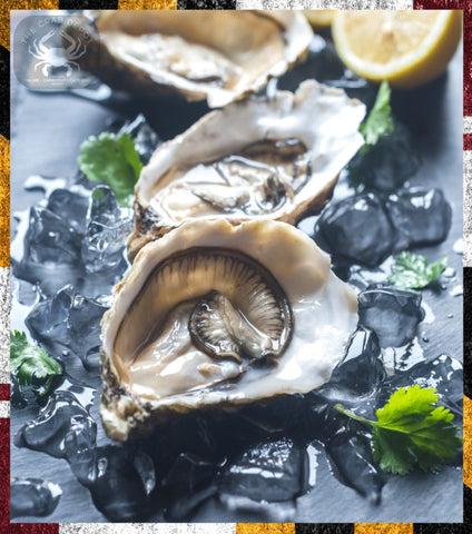 Oysters on ice with lemon wedges and parsley on a dark surface
