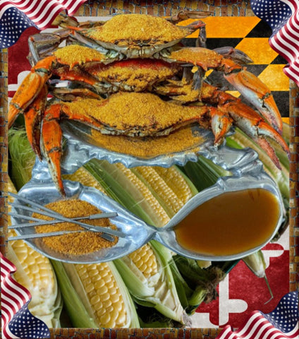 A plated seafood spread featuring several cooked crabs topped with yellow seasoning, fresh corn on the cob, a silver serving dish, and a small bowl of brown dipping sauce, set against a decorative American flag and checkered border.